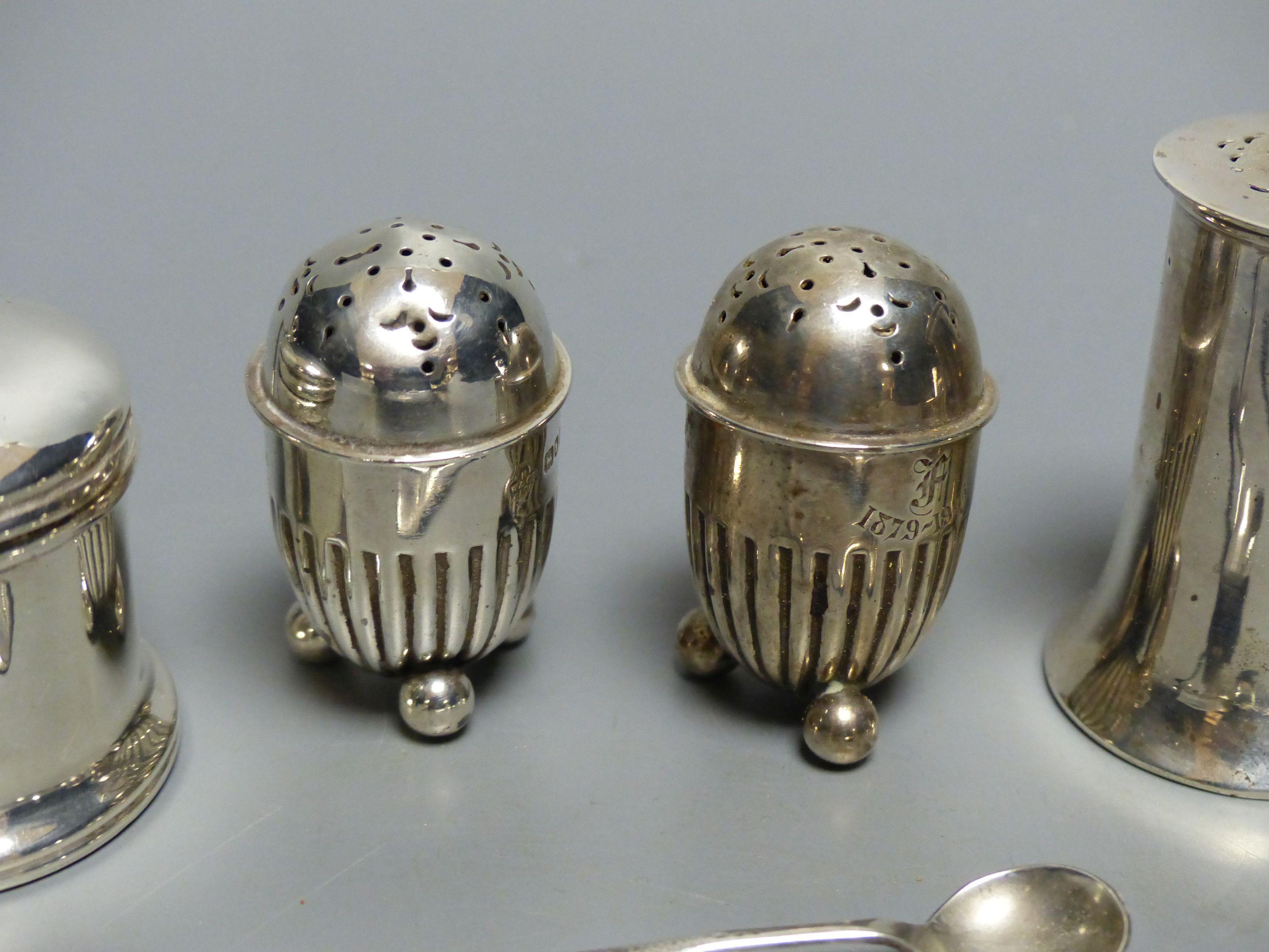 A collection of silver condiments, including a Norwegian 'Viking' longboat salt,